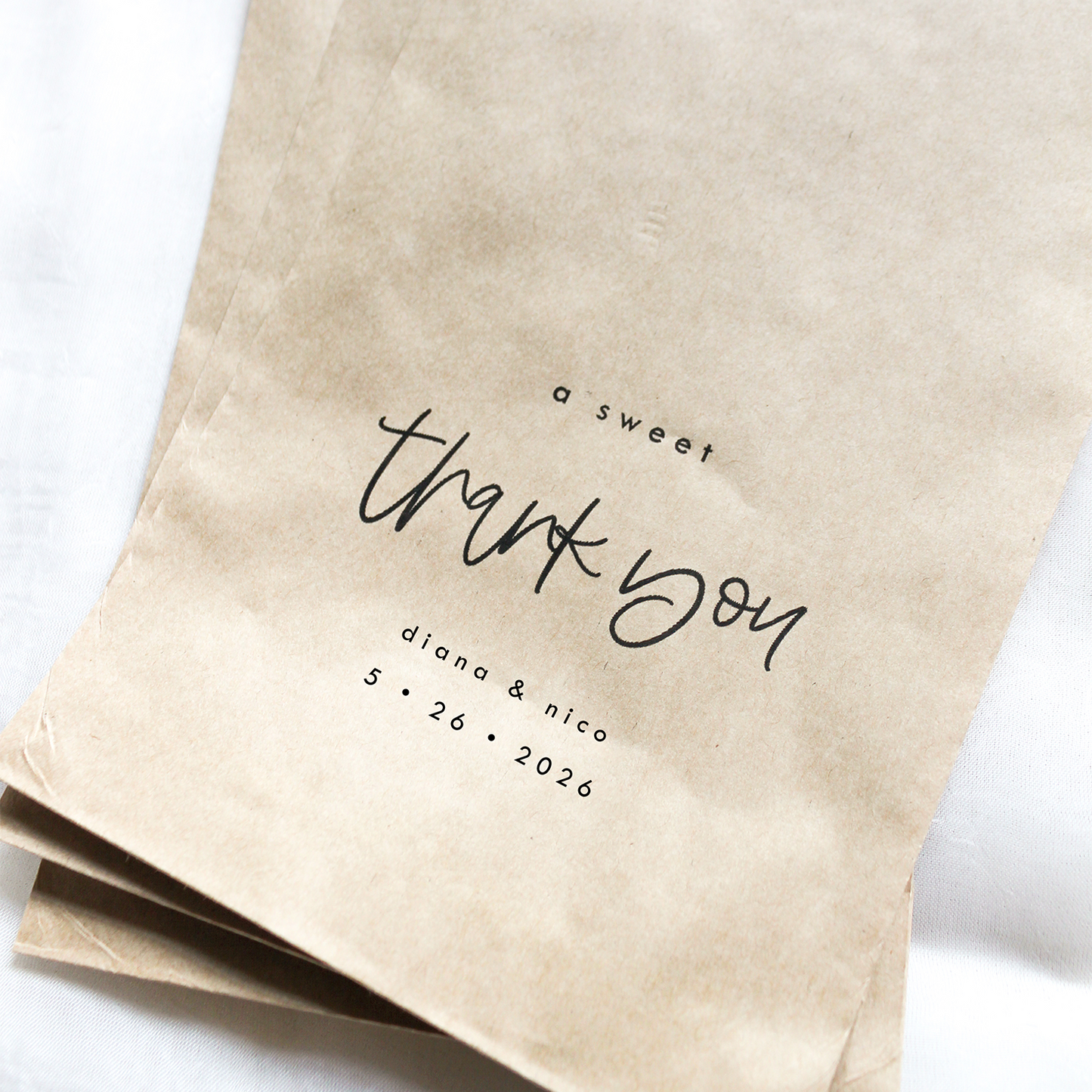 Three brown paper bags with 'a sweet thank you' text on a white background