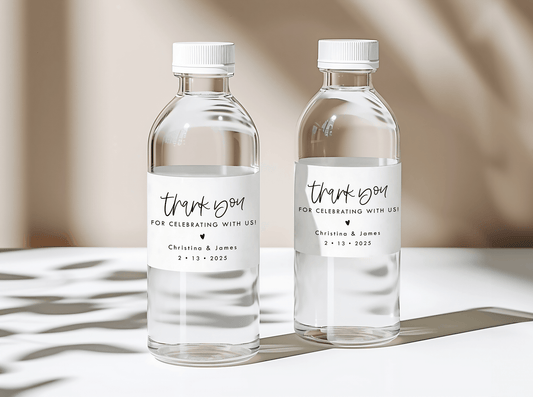 personalized wedding water bottle labels that say "thank you for celebrating with us" with a heart underneath, and couple names and date. 
