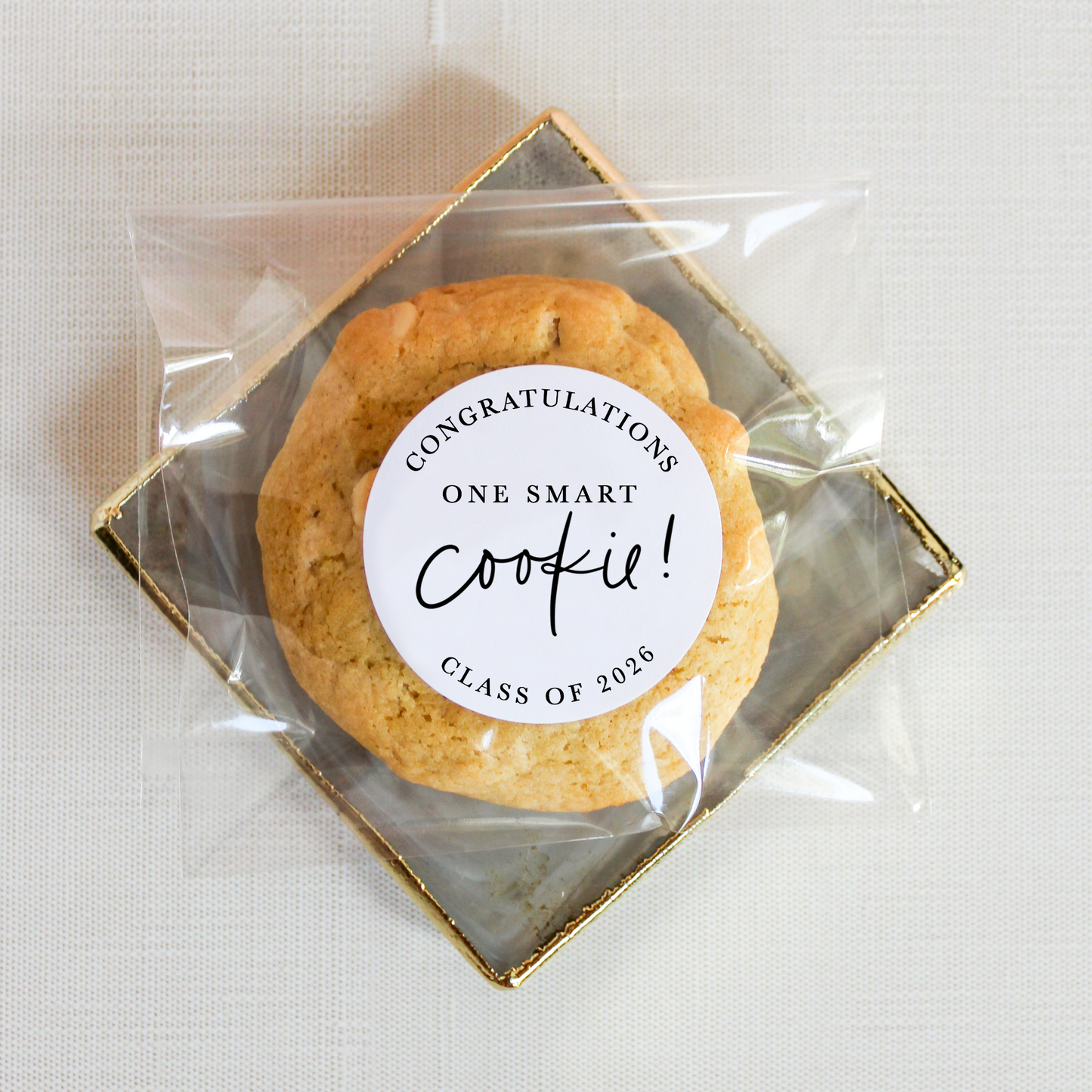 Cookie in clear packaging with a 'Congratulations One Smart Cookie!' label on a light background