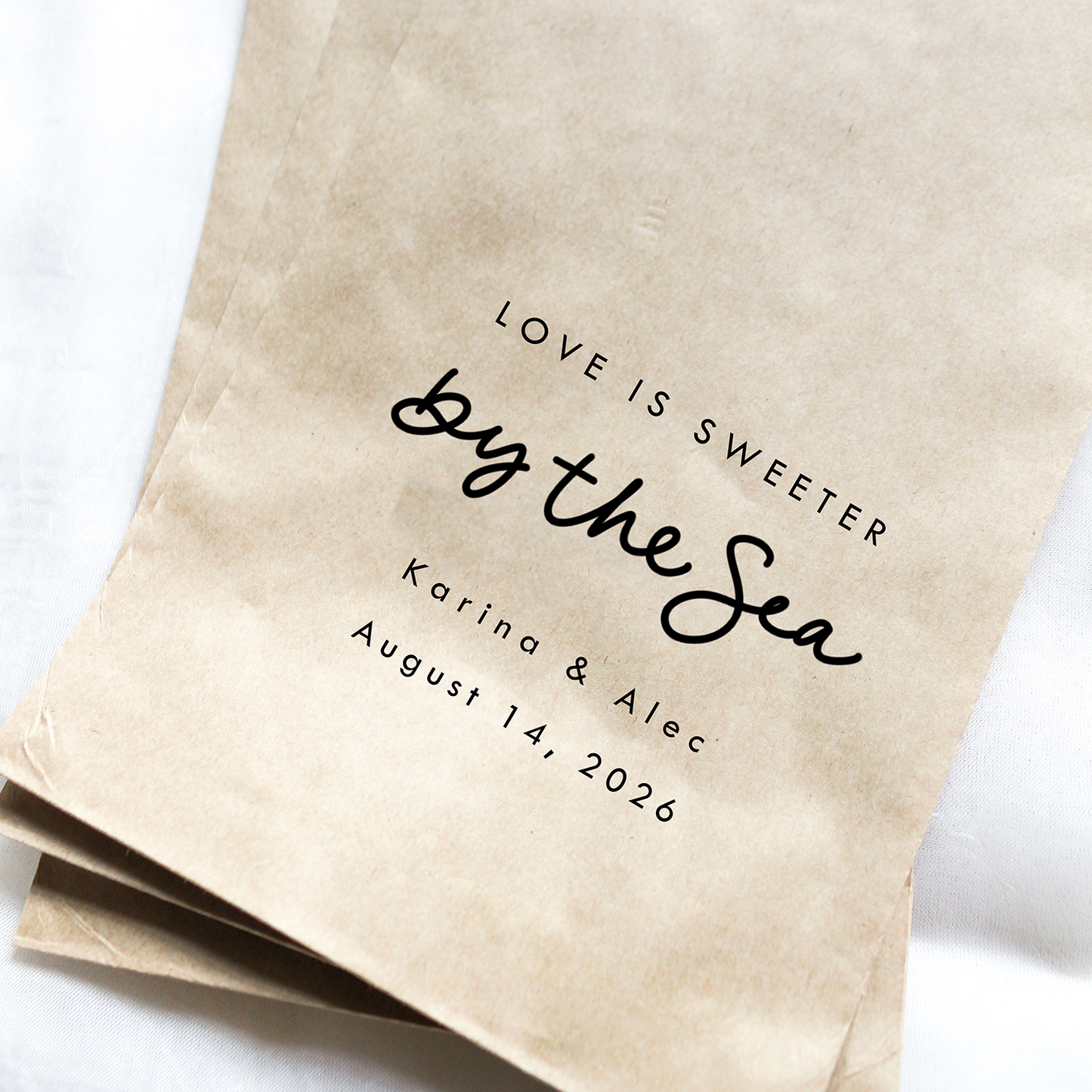 Brown paper bags with personalized text on a white background