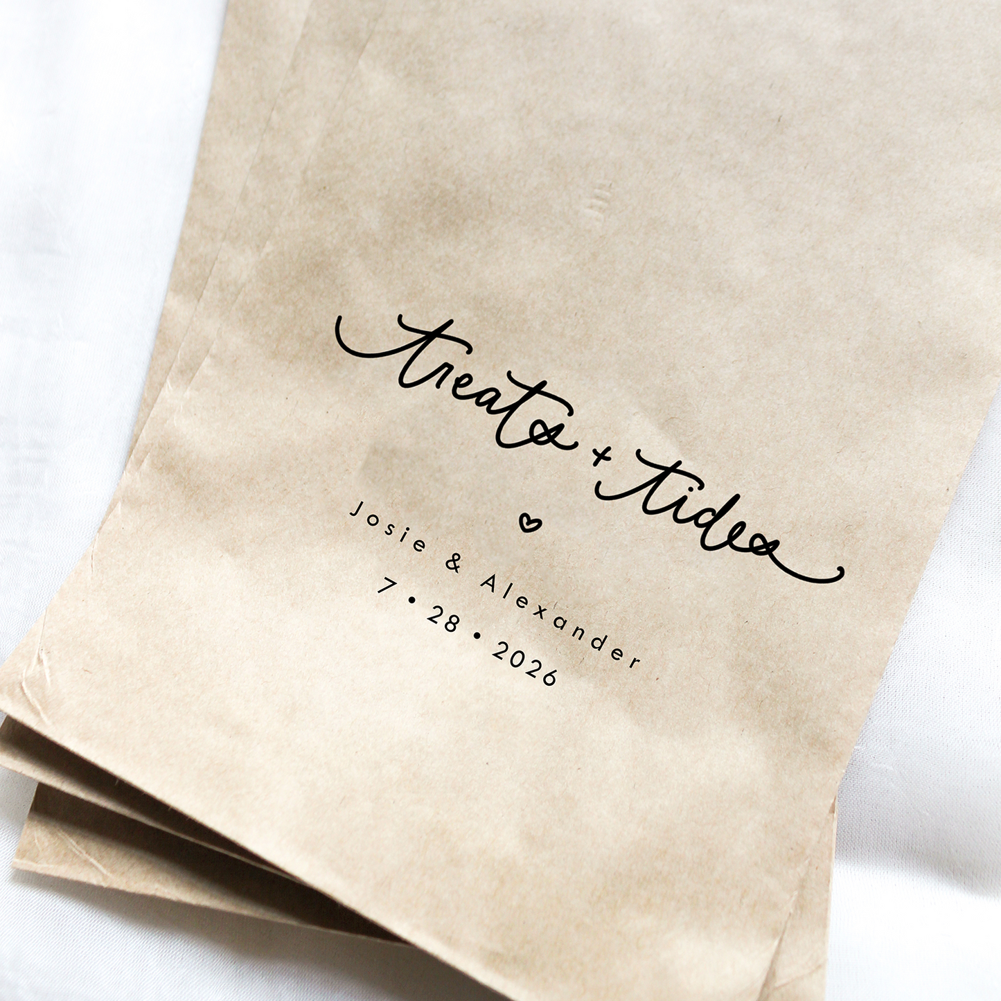Kraft paper bags with personalized text on a white background