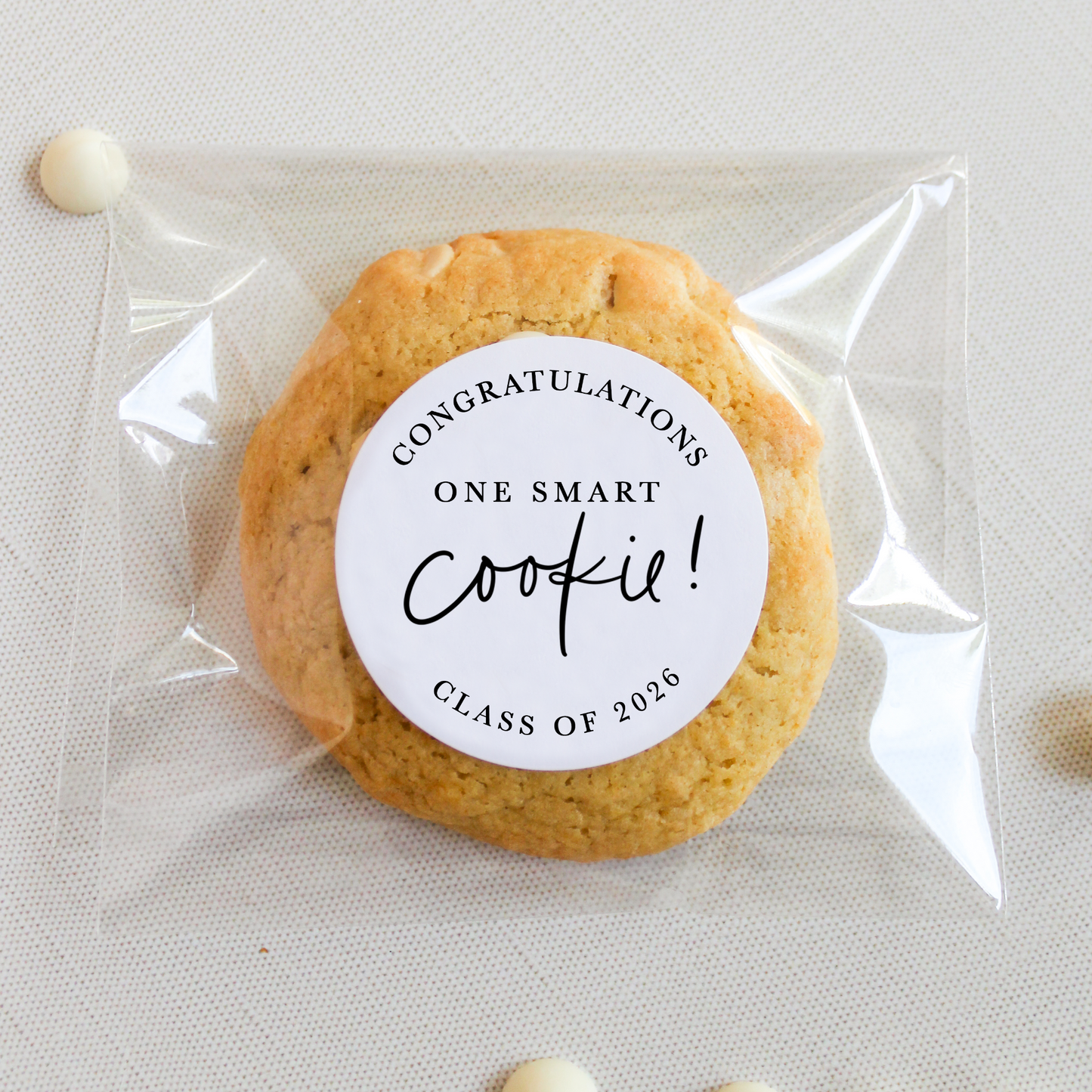 Cookie with a 'Congratulations One Smart Cookie! Class of 2026' label in clear packaging on a light background.