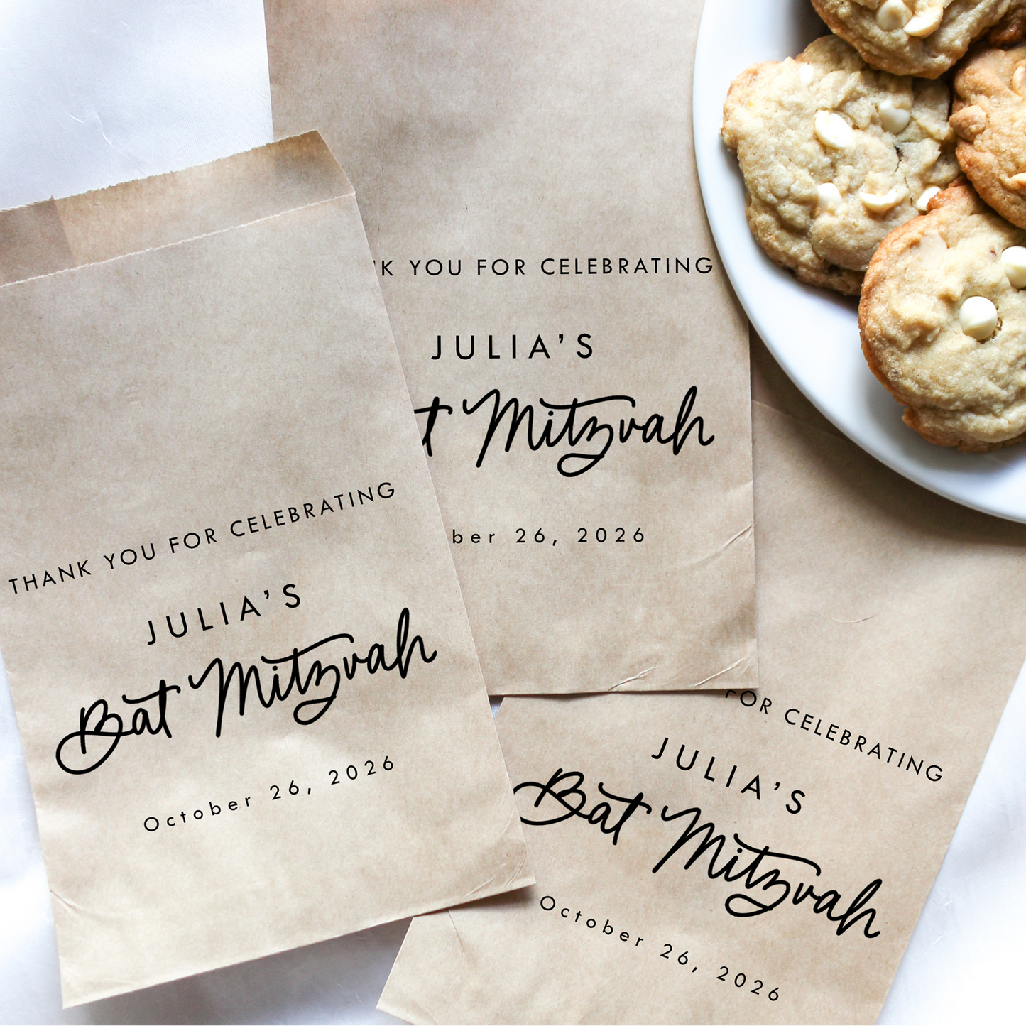 Personalized brown paper bags for Julia's Bat Mitzvah with a plate of cookies.