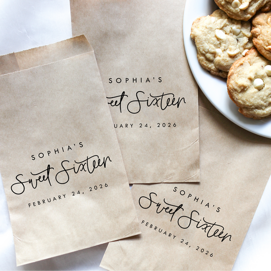 Personalized brown paper bags for a Sweet Sixteen party with cookies on a plate.