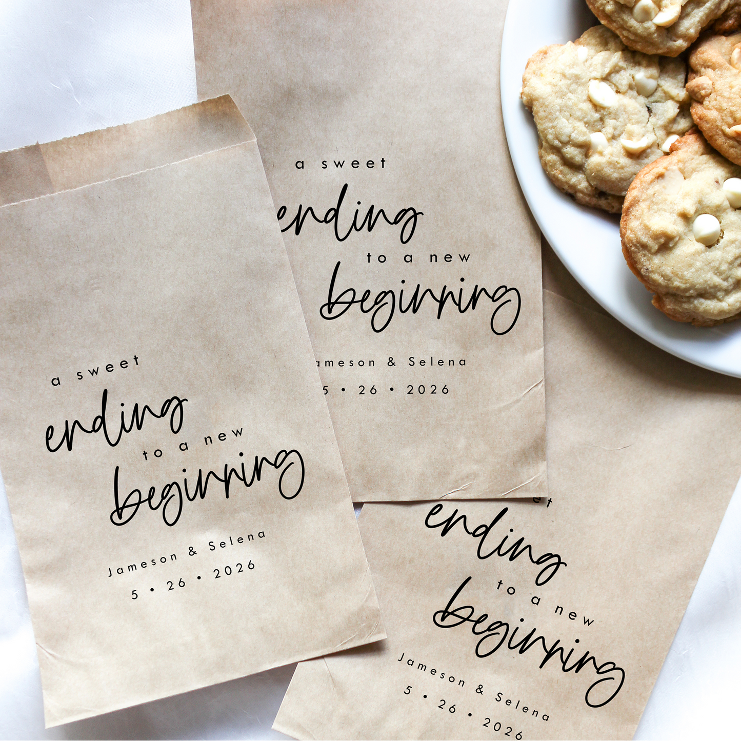 Personalized brown paper bags with 'A sweet ending to a new beginning' text, next to a plate of cookies.