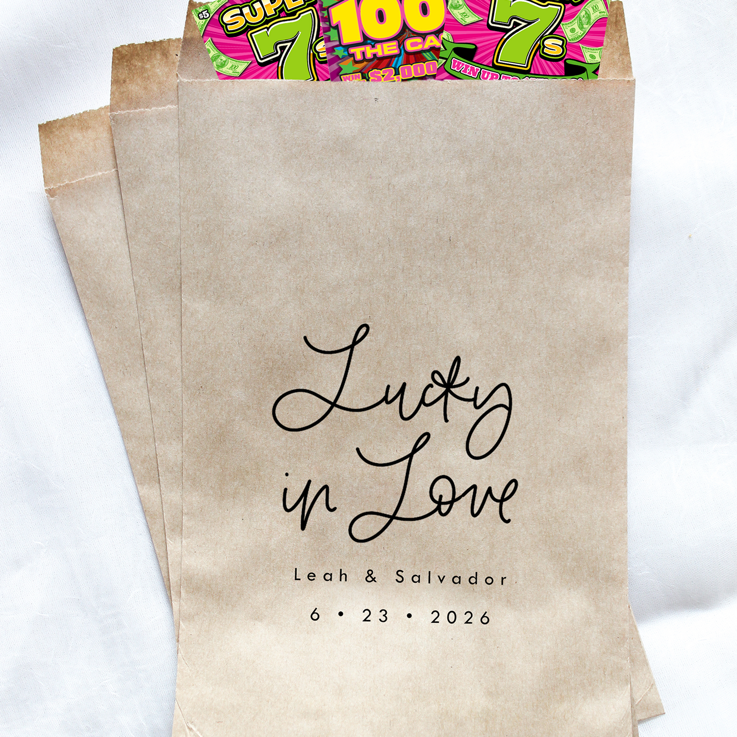Kraft paper bags with personalized text and colorful lottery tickets on a white background