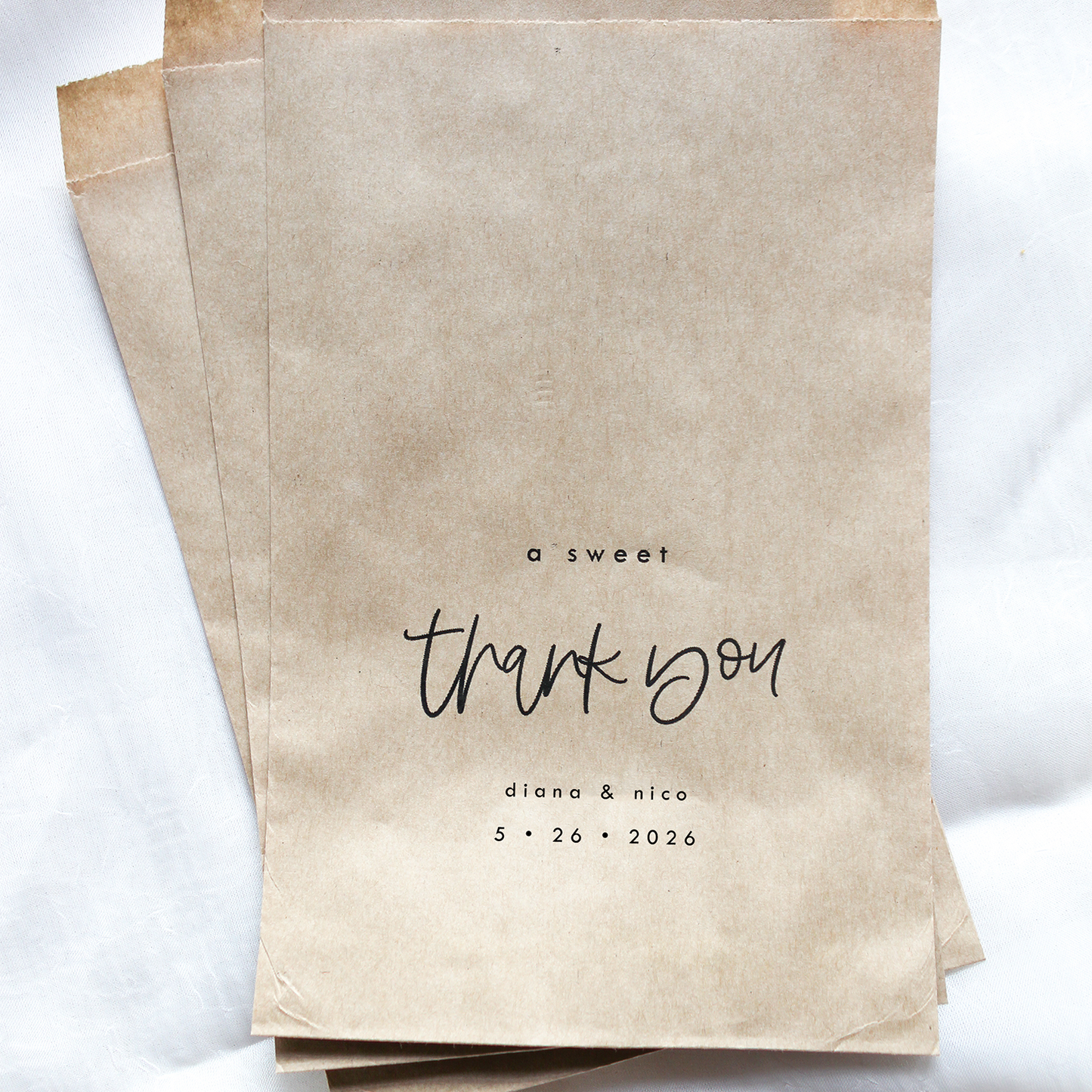 Kraft paper bags with 'a sweet thank you' text on a white background