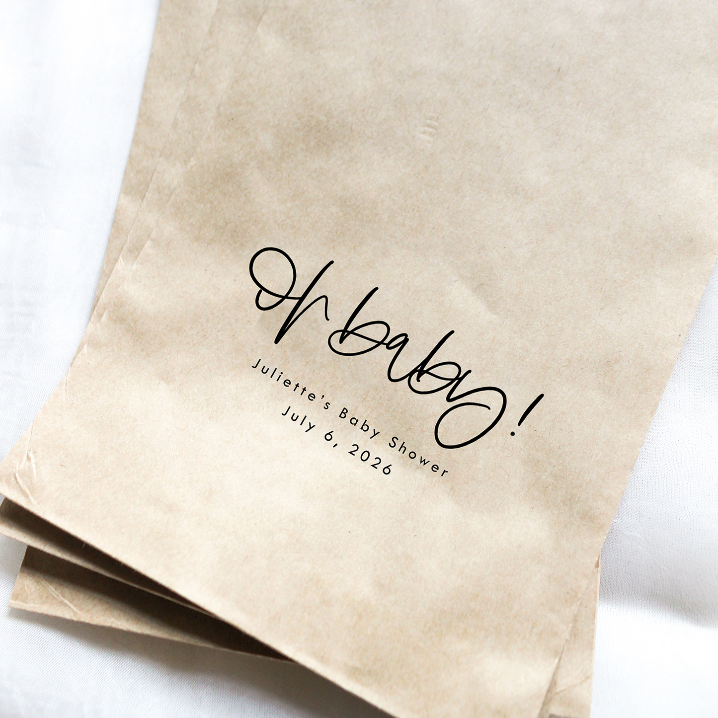Brown paper bags with 'Oh baby!' text on a white background