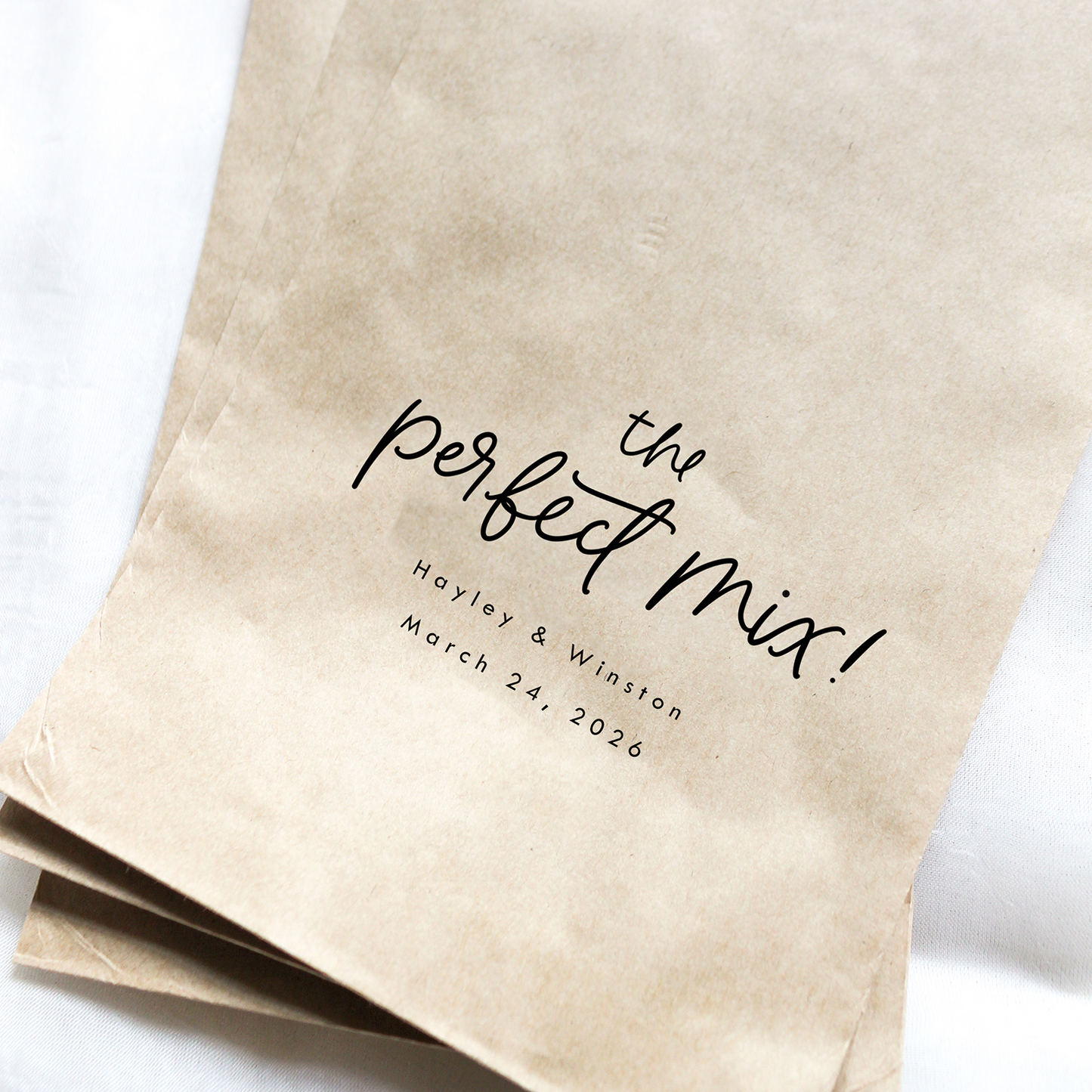 Two brown paper bags with 'the perfect mix!' text on a white background