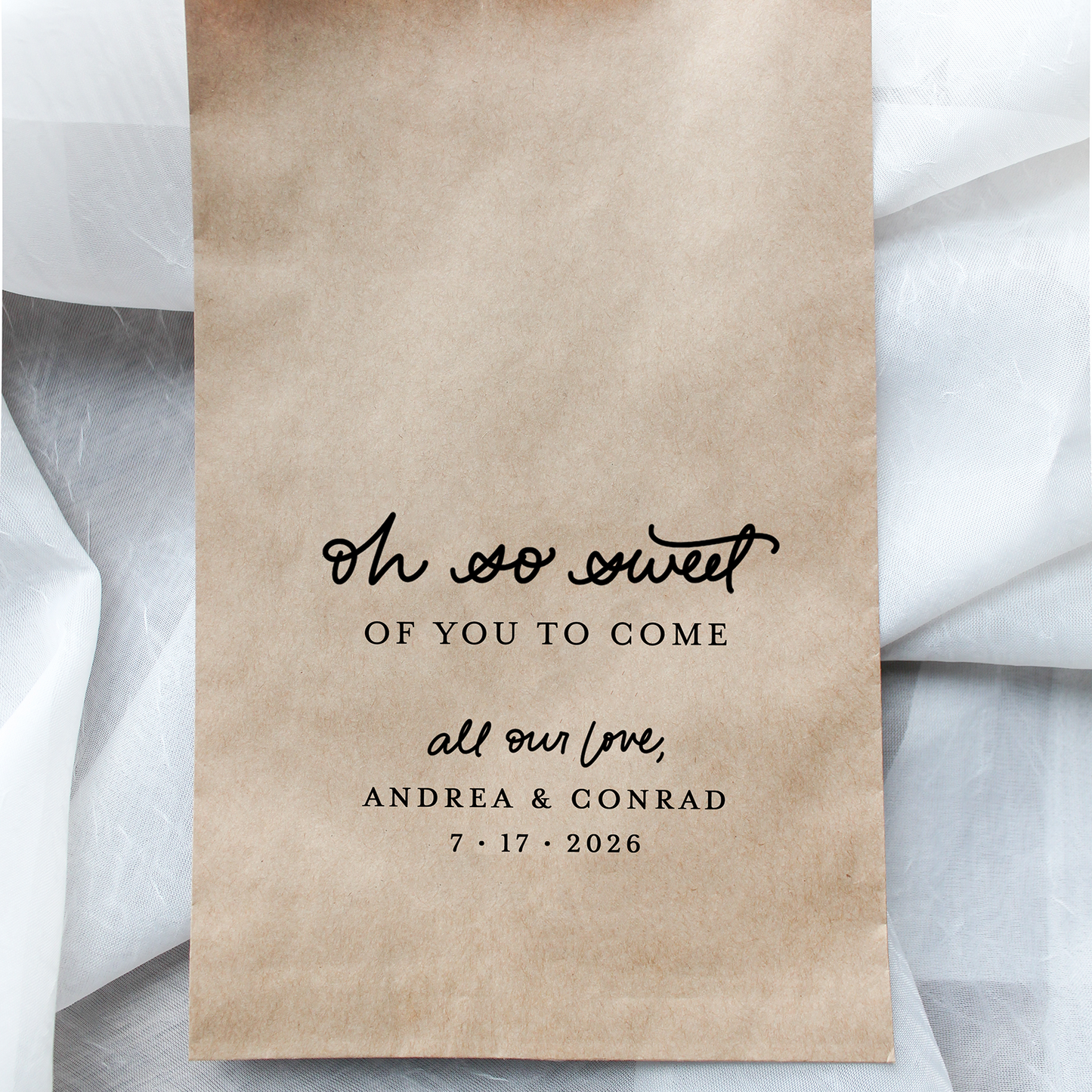 Brown paper bag with personalized text on a white fabric background