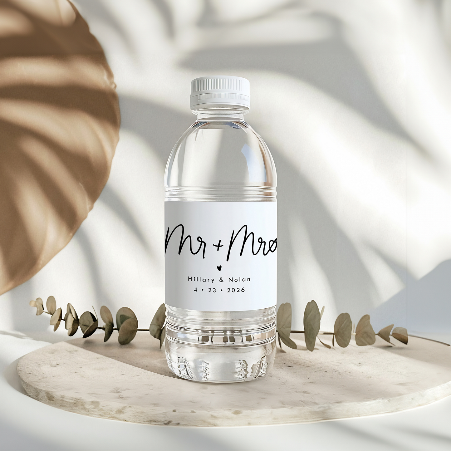 Bottle of water with a 'Mr & Mrs' label on a light background