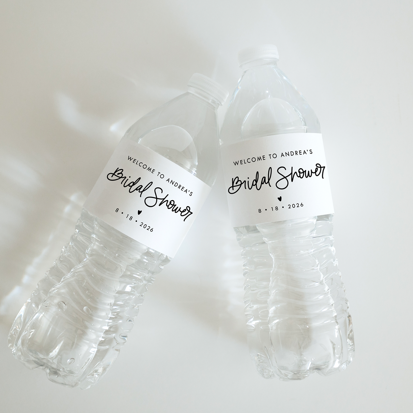 Two clear plastic cups with 'Welcome to Andrew's Bridal Shower' labels on a white background.