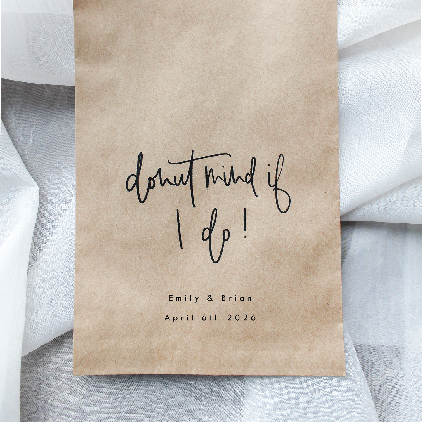 Kraft paper bag with 'donut mind if I do!' text on a light gray background