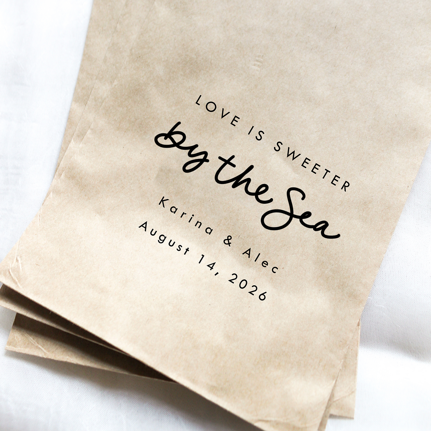 Brown paper bags with personalized text on a white background