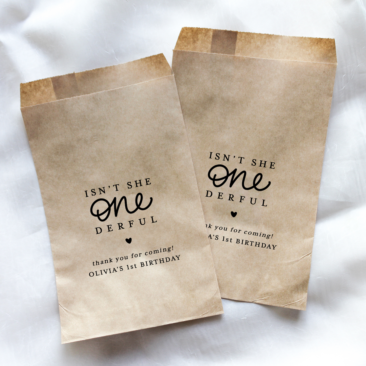 Two brown paper bags with black text on a white background