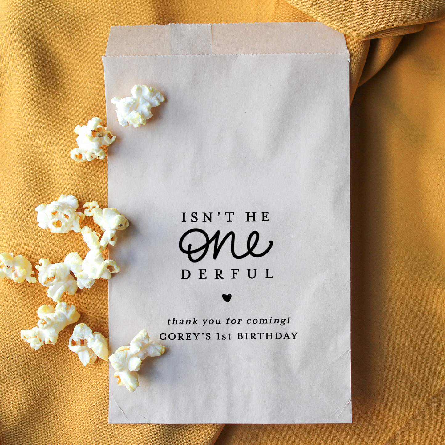Paper bag with popcorn and personalized text on a mustard yellow background