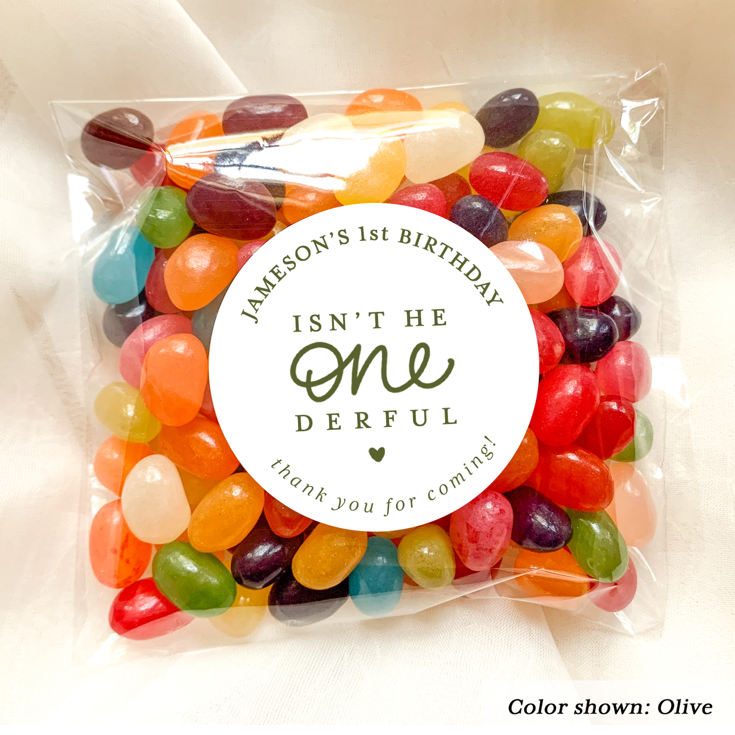 Bag of colorful jelly beans with a personalized label on a white background